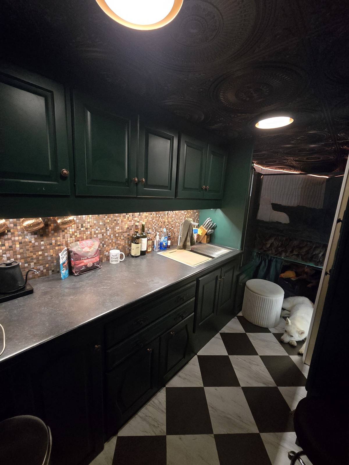 Finished custom green cabinetry with butcher-block counters