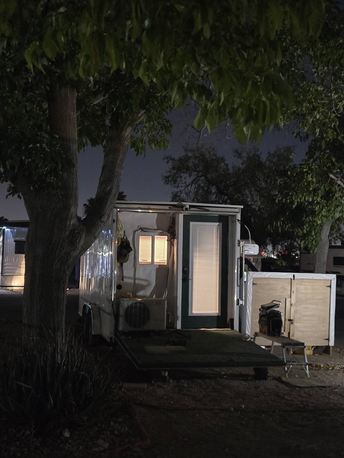Andrew's finished custom off-grid trailer parked at a campground at night