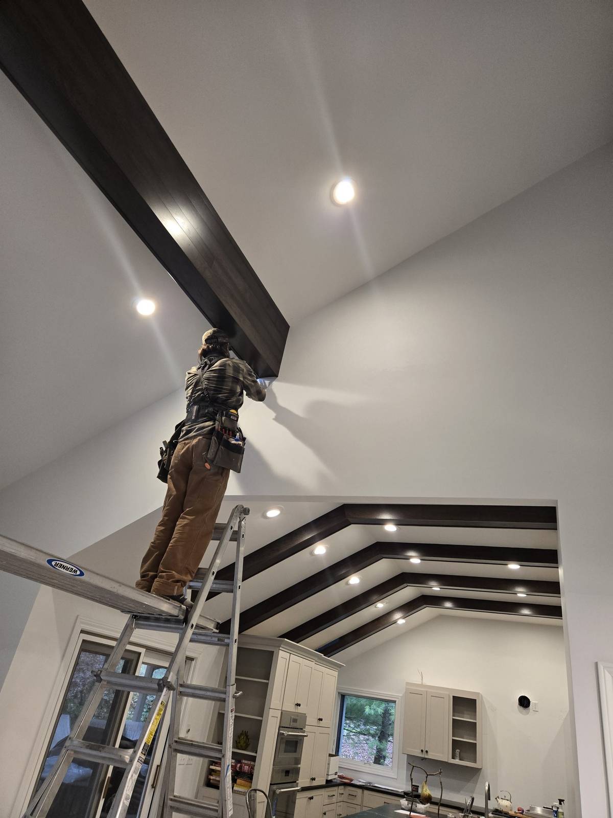 Ceiling beam installation in a vaulted living space