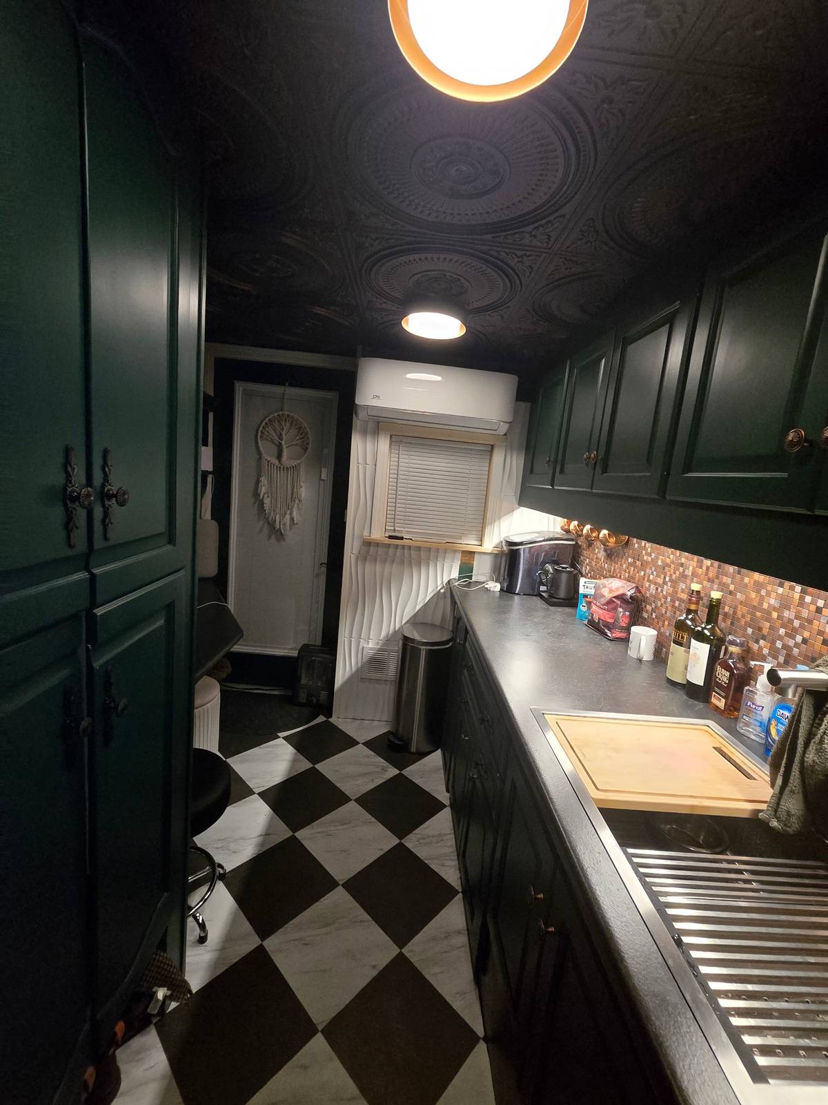 Finished green galley kitchen inside Andrew's custom off-grid trailer